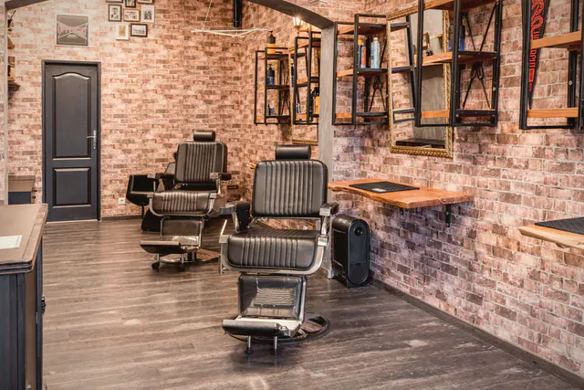 Inside the shop: three leather chairs and the long mirror