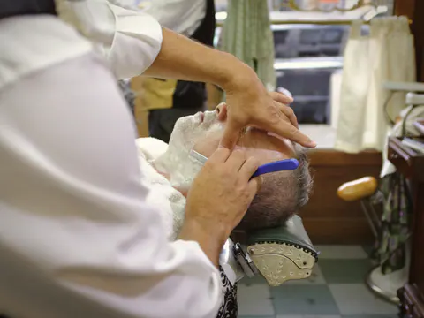 Straight razor shave with a hot towel on the chair side