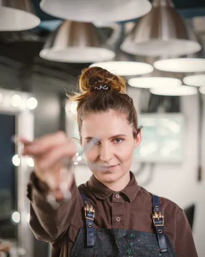 Jess Crane holding clippers, smiling at the camera